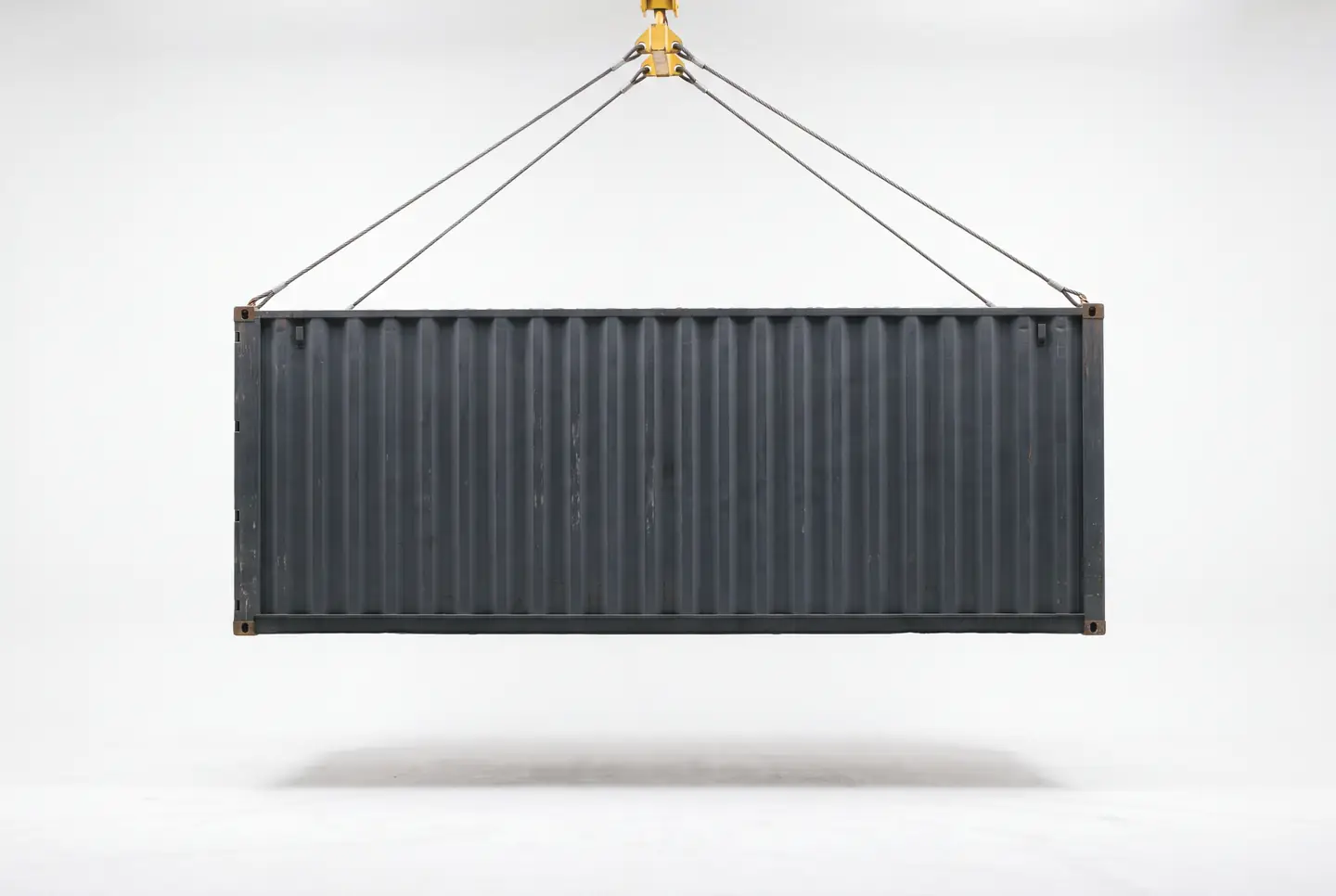 Charcoal shipping container carrying the Sailix logo, hanging from a crane